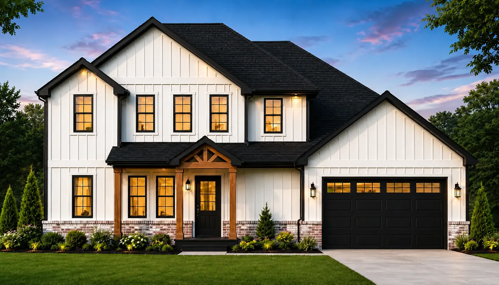 Modern CAMRYN two-story house with white vertical siding, black trim, and a sleek black roof. Warm lights shine from the windows, creating an inviting atmosphere. There is a front porch with wooden posts and an attached two-car garage. Bushes and a green lawn complete the welcoming front exterior