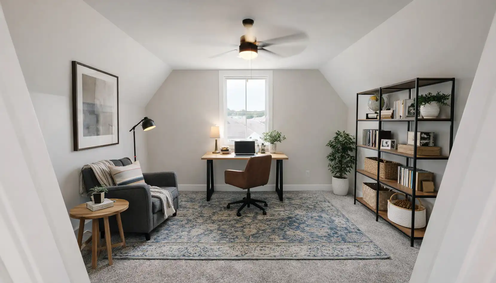A modern home office with a desk, office chair, armchair, standing lamp, bookshelf, potted plant, and wall art creates an inviting workspace. A window lets in natural light while a ceiling fan is overhead. The cozy décor is minimalist—perfect for Sophia’s productive and inspiring environment