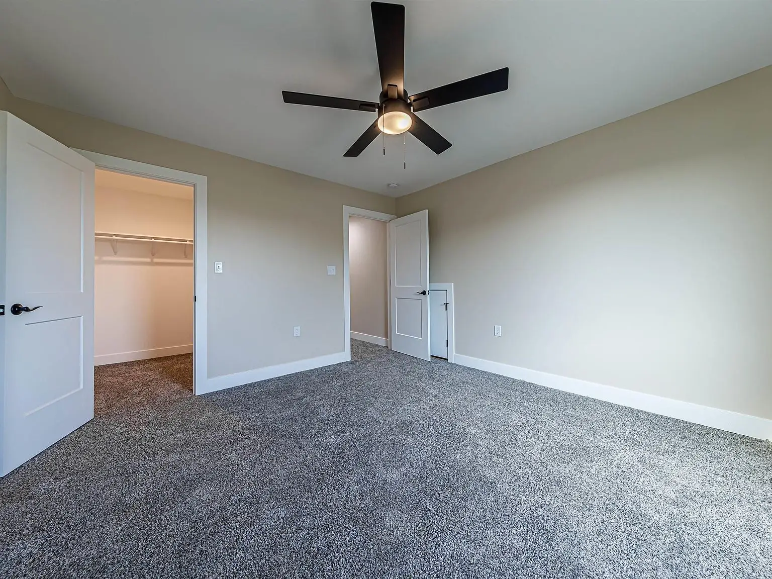Empty carpeted bedroom in the DaVinci floor plan at Chris Brown Homes 18739 Roscommon Rd.