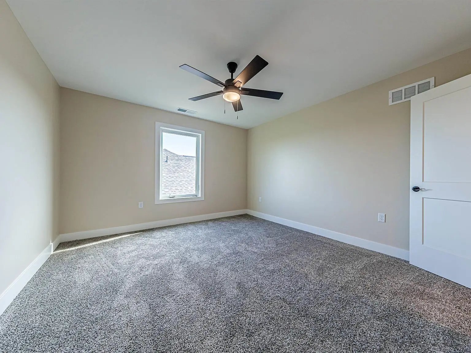 Empty carpeted room in the DaVinci floor plan by Chris Brown Homes 18739 Roscommon Rd.