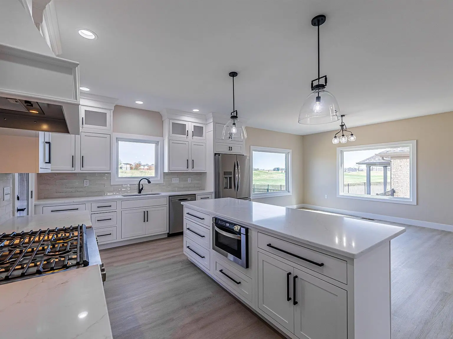 Modern kitchen in Chris Brown Homes 18739 Roscommon Rd, with DaVinci floor plan and island.