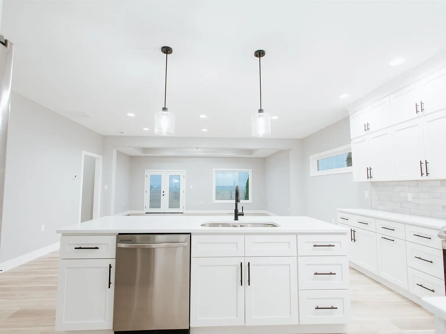 Modern white kitchen with island at Chris Brown Homes 923 Taversham Ave, bright and inviting.