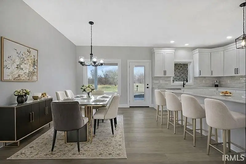 Modern dining area, white cabinets, bar stools—Ava floor plan by Chris Brown Homes 6100 Ashford Dr.