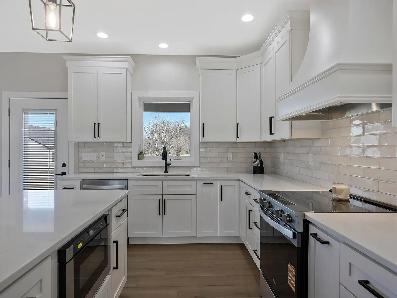 Modern kitchen in the Ava floor plan features white cabinets and stainless appliances.
