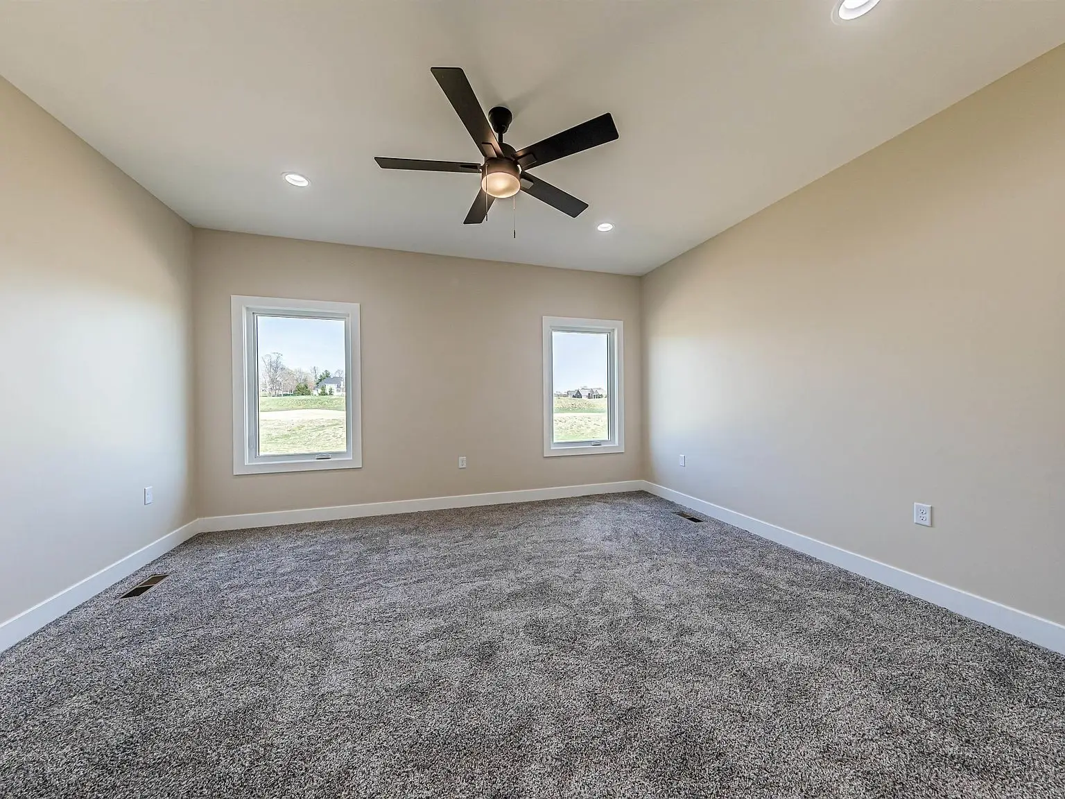 Empty carpeted room with DaVinci floor plan, beige walls, ceiling fan, and recessed lighting.