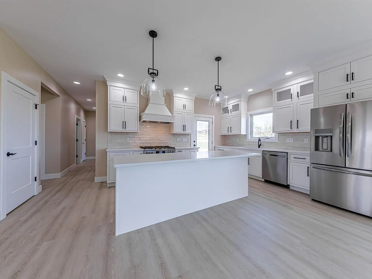 Modern kitchen: DaVinci floor plan, white cabinets, stainless appliances by Chris Brown Homes.