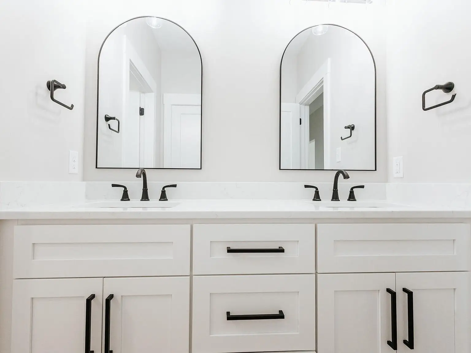 White double vanity with black fixtures highlights the Harper floor plan in this bright bathroom.