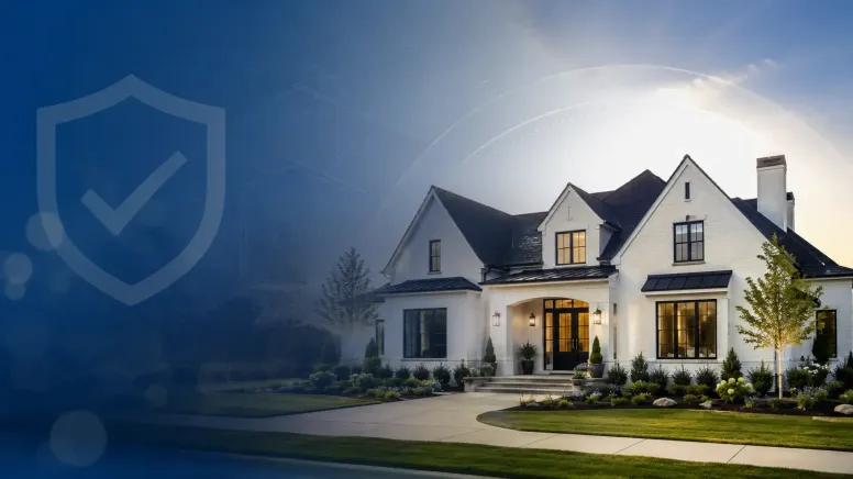 A large, modern white house with a dark roof sits on a manicured lawn. The left side of the image has a semi-transparent blue overlay with a shield and checkmark icon, suggesting security or protection—perfect for illustrating topics in your home security blog.