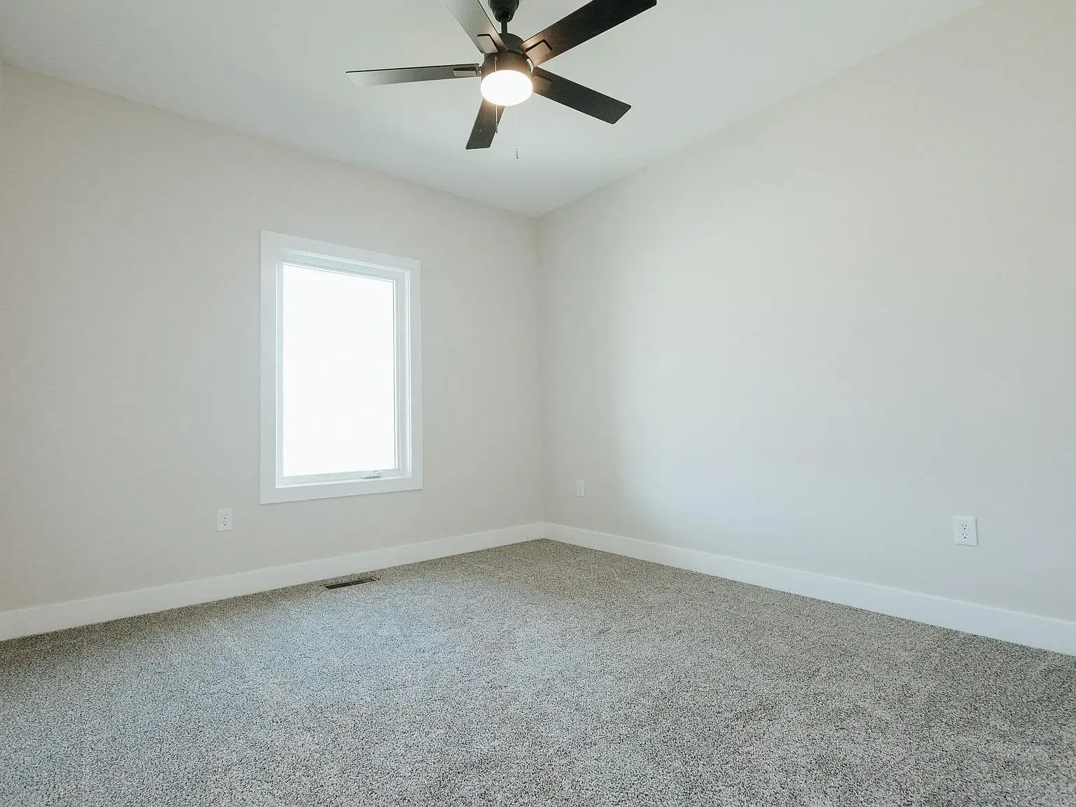 Empty room at Chris Brown Homes 18801 Roscommon Rd with beige walls and Asher floor plan.