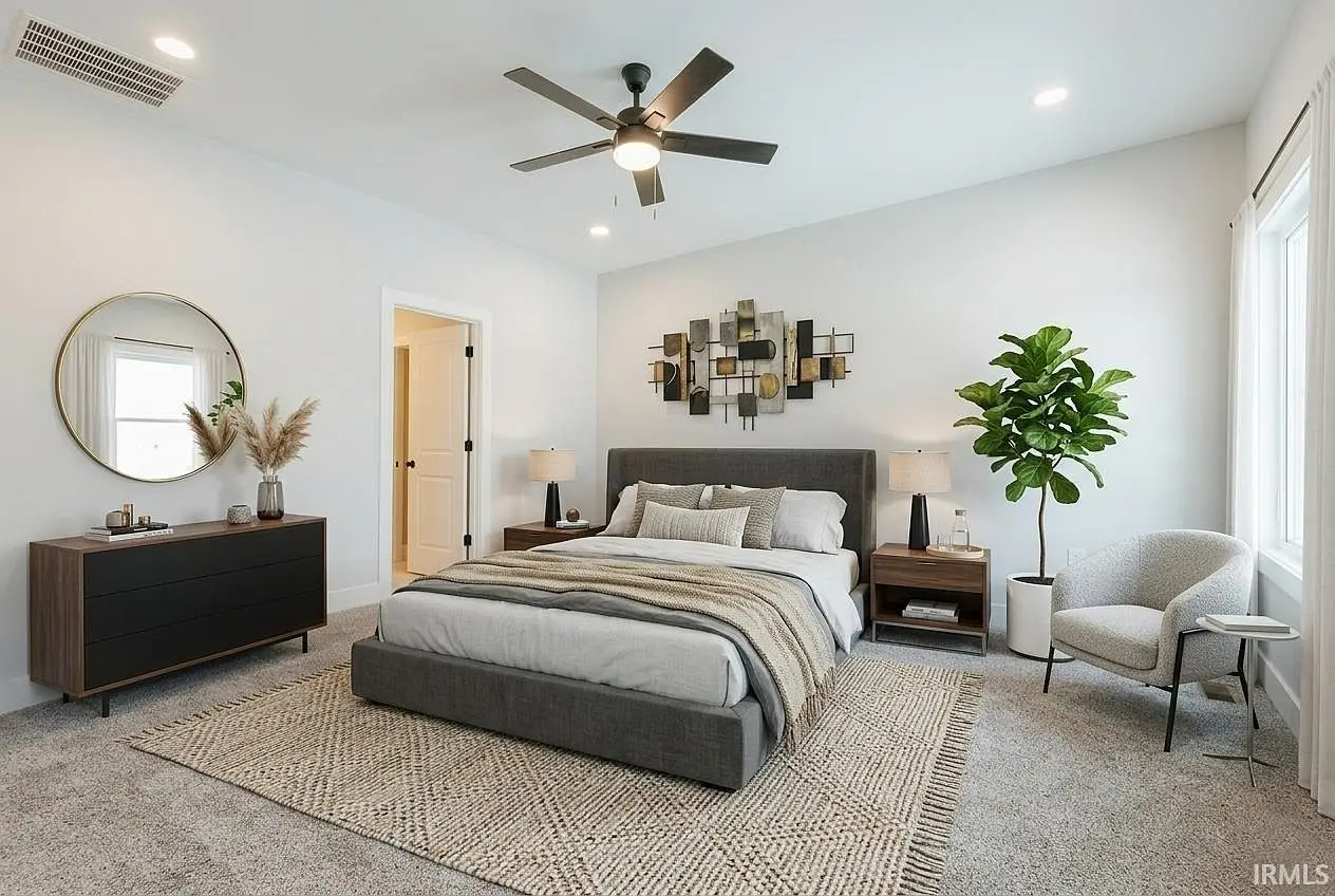 Modern bedroom in the Asher floor plan with gray bed, nightstands, dresser, and wall art.