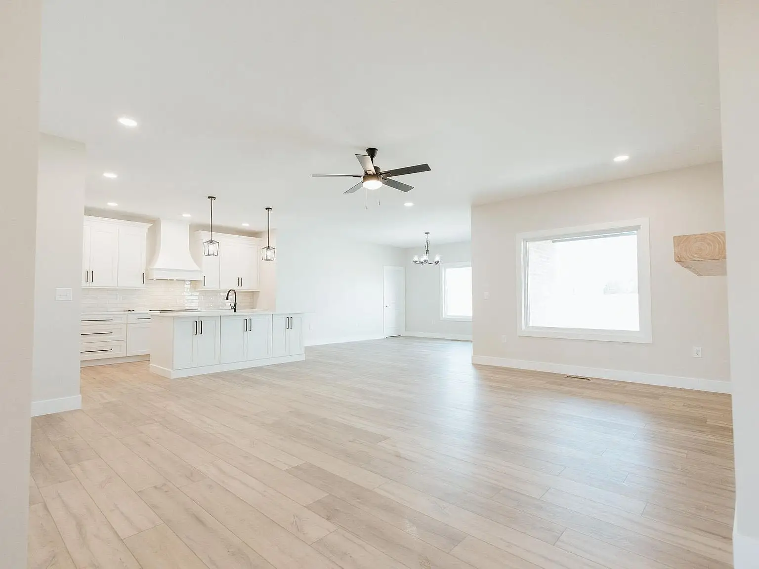 Spacious open-concept living area with wood floors, Asher floor plan by Chris Brown Homes.