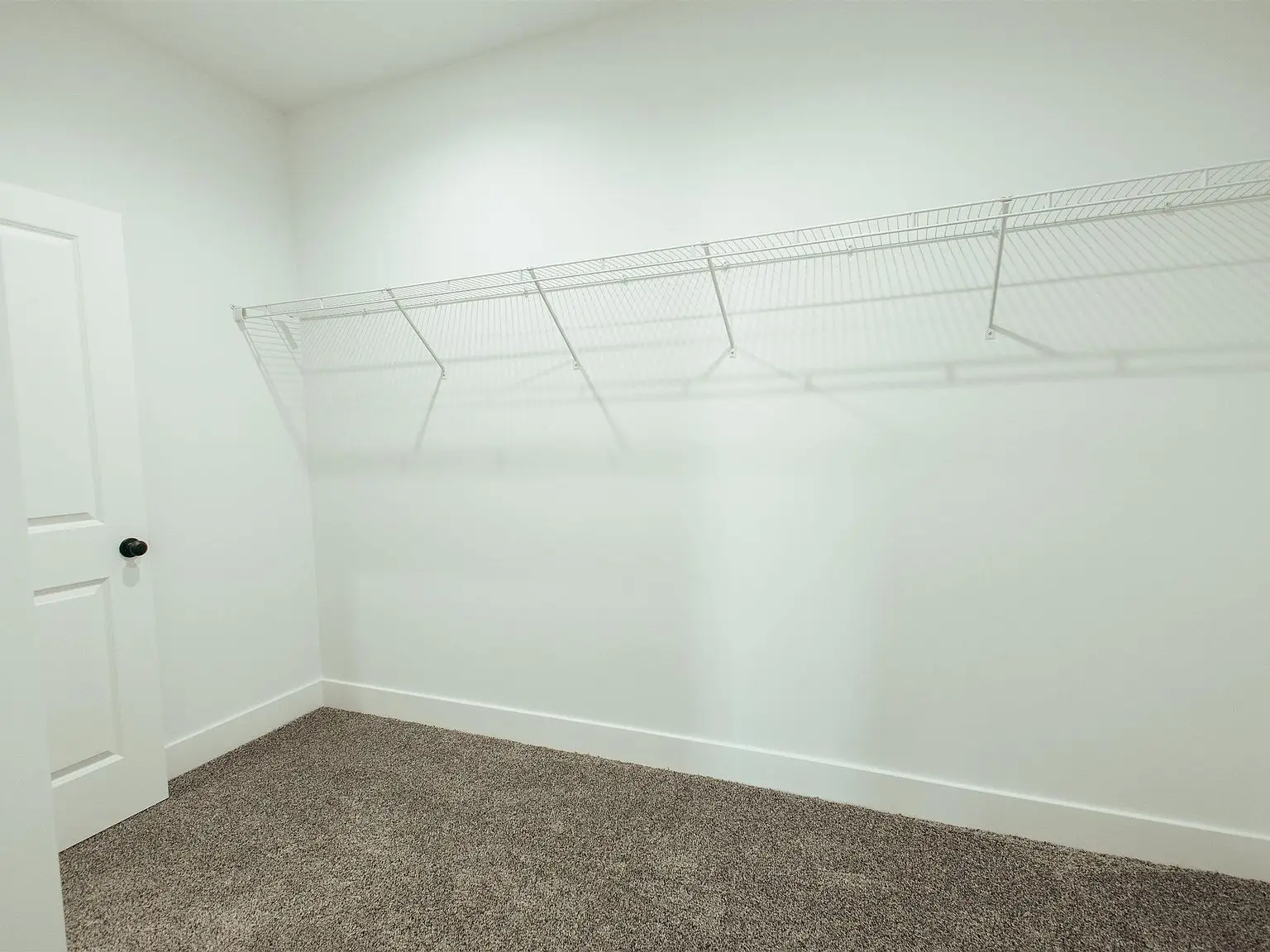 Empty walk-in closet in Chris Brown Homes 1624 Eli Dr, part of the Kirkwood floor plan.
