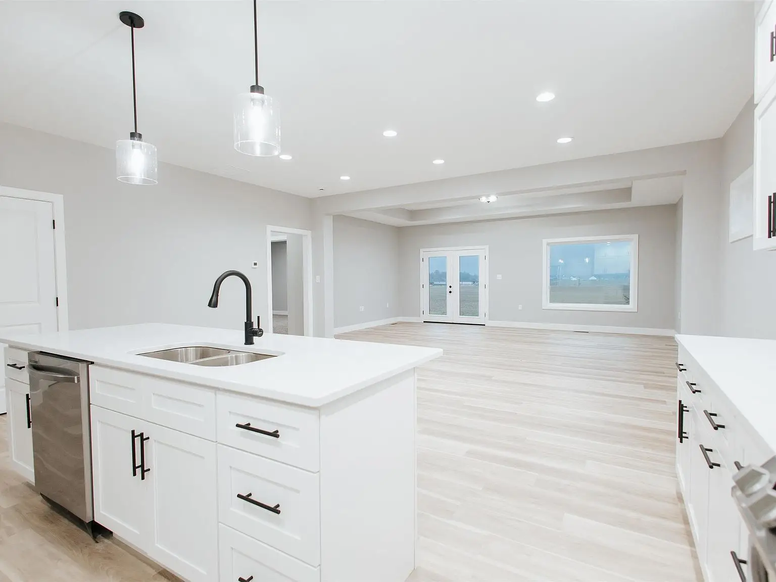 Modern kitchen at Chris Brown Homes 923 Taversham Ave with open space leading to living area.