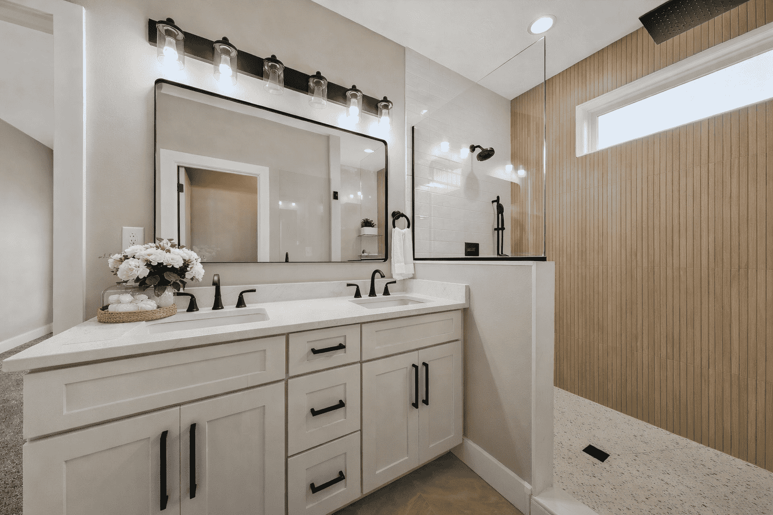 Modern double vanity and glass walk-in shower at 18800 Wicklow Way in Aurora.