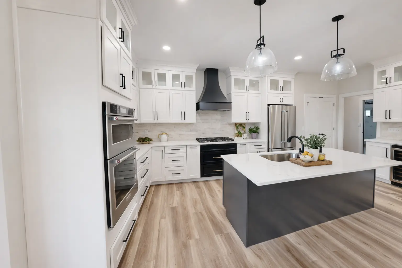 Modern Asher kitchen by Chris Brown Homes in Aurora with white cabinets and charcoal island