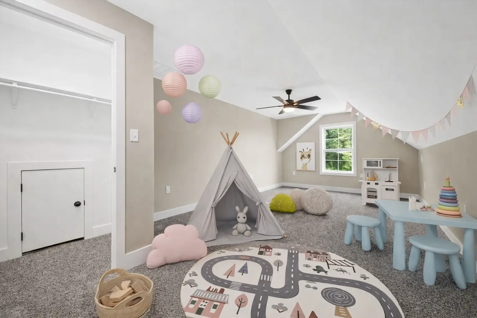 Aurora playroom at 18800 Wicklow Way with teepee, toy kitchen, table, and road-map rug.