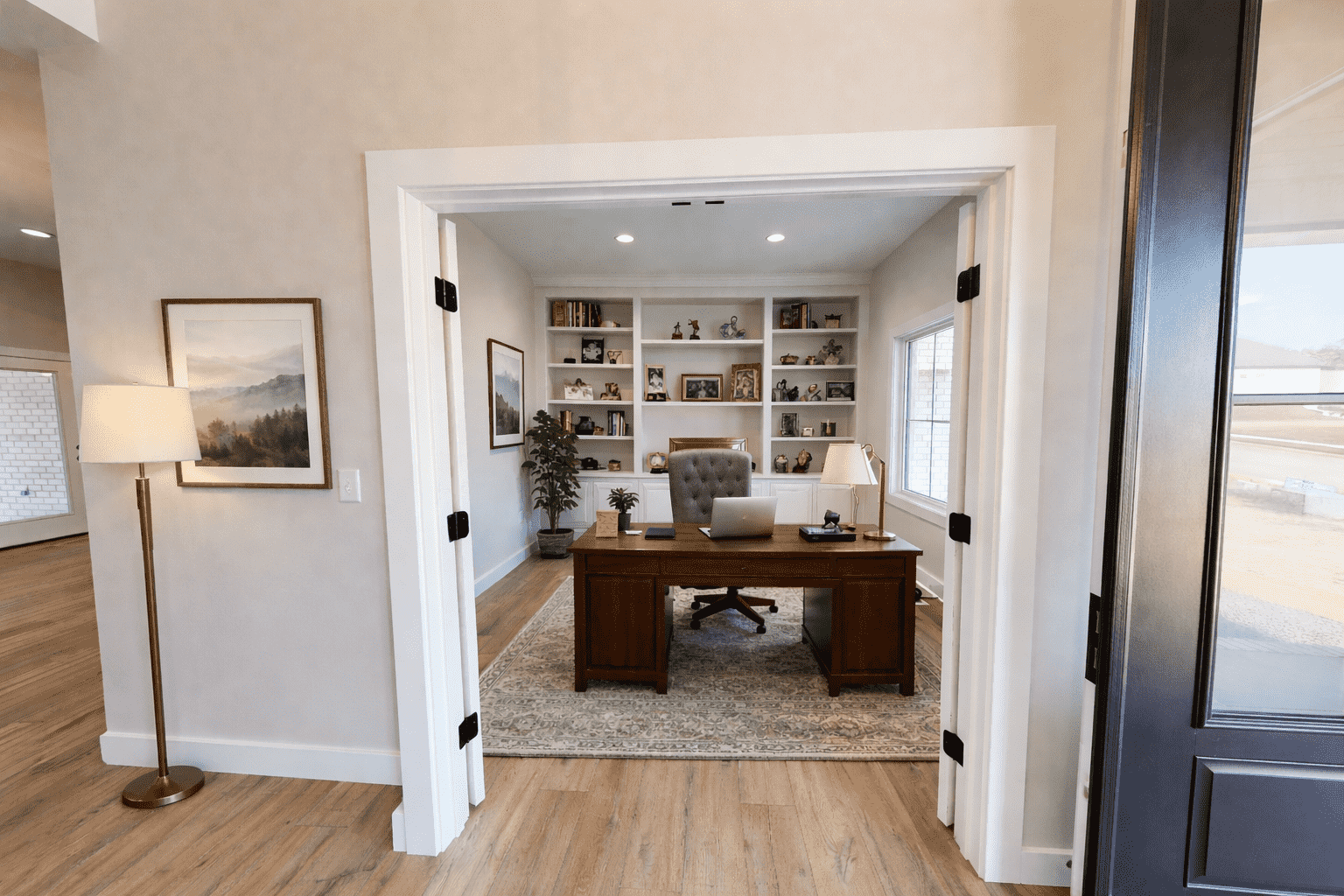 Elegant home office with dark wood desk and built-in shelves at 5588 Lenox Dr.