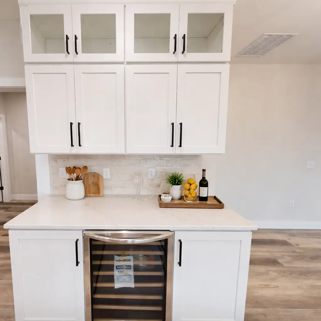 Modern white beverage bar with wine cooler at Chris Brown Homes in Aurora.