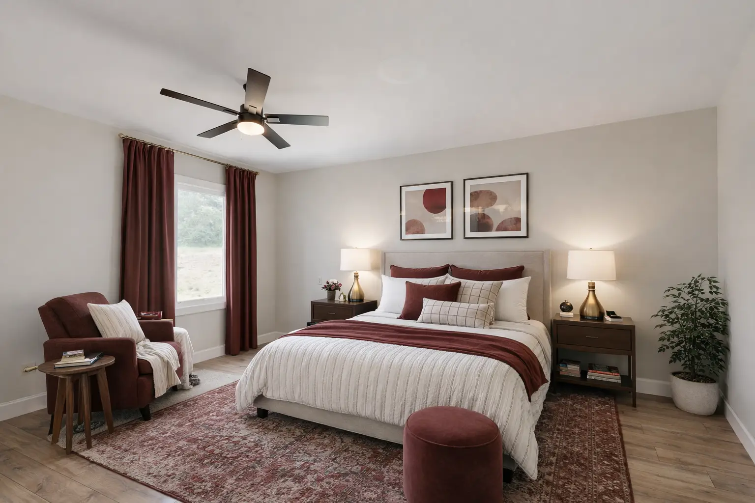 Warm contemporary bedroom with burgundy accents, upholstered bed, reading chair, and Persian-style rug.