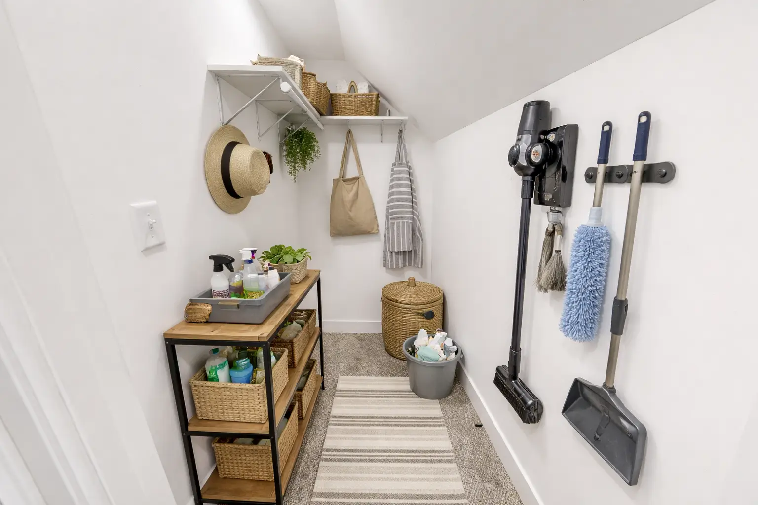 Chris Brown Homes utility closet with woven baskets and wall-mounted tools at 5588 Lenox Dr.