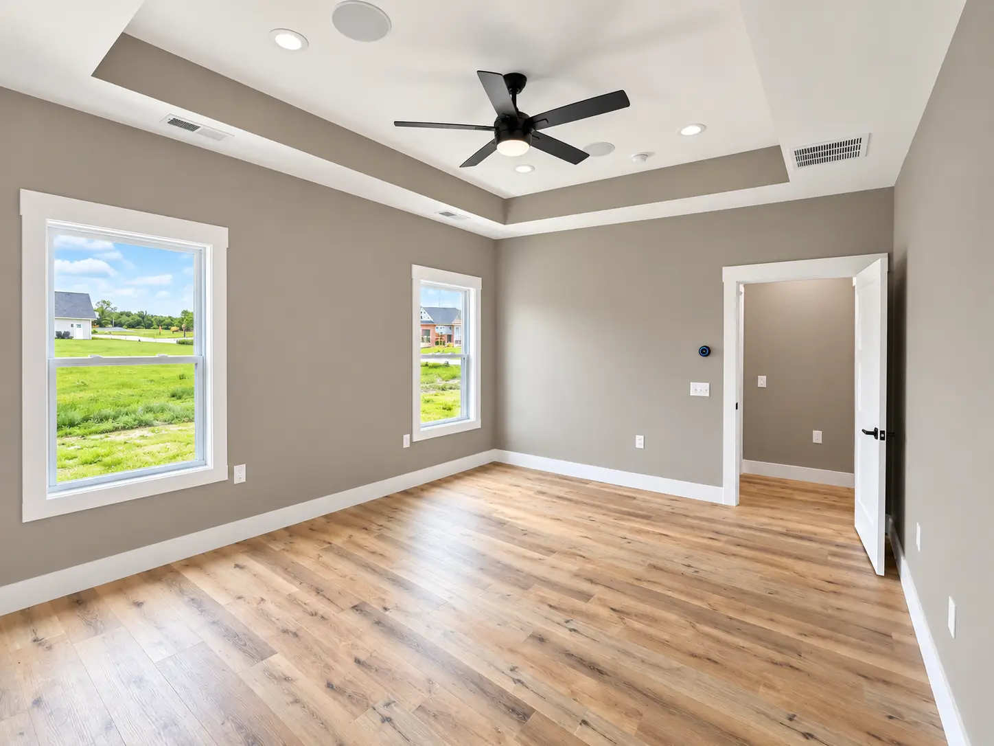 Bright Kirkwood Room With Wood Floors and Ceiling Fan