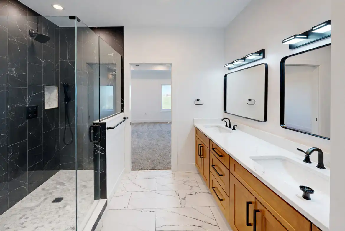 Modern Leo bathroom with black marble shower, wood double vanity, and matte-black fixtures.