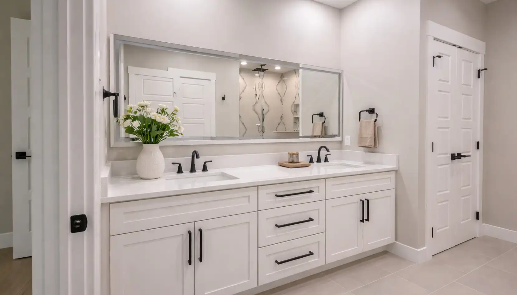 Move-in-ready Harper floor plan bathroom with double vanity, white cabinets, and black fixtures.